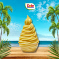 Dole pineapple soft serve ice cream with a tropical background featuring palm trees and a blue sky.